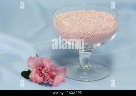 Pink bath granules with azalea blossom Stock Photo