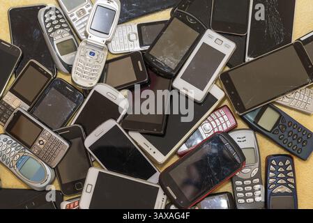 Used smartphones collected - raw material recycling mobile phone collection campaign Stock Photo