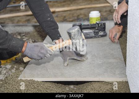 Craft tiler on a construction site - construction workers and construction industry Stock Photo