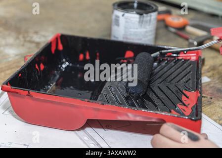A foam roller is stripped in an ink tray Stock Photo