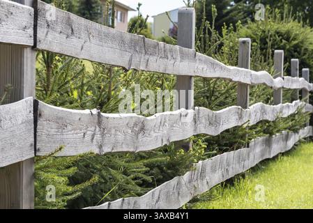 Garden fence made from old boards as a privacy screen and boundary - picket fence Stock Photo