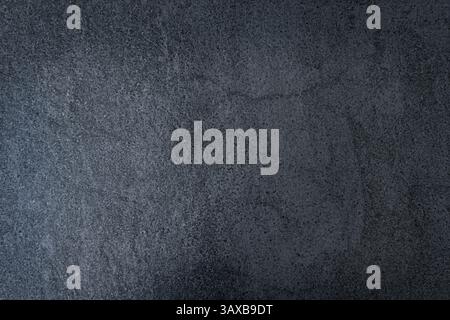 Dark gray textured concrete surface. A close-up view of a dark gray concrete surface with a rough and textured finish. Top view. Free space for your Stock Photo