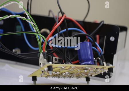 Electronic circuit board with capacitor, connections and wires Stock Photo