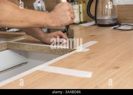 Carpenter with handsaw sawing and woodworking - Handicraft Stock Photo