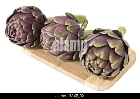 Three fresh artichokes on a wooden board Three fresh artichokes on a cutting board Stock Photo