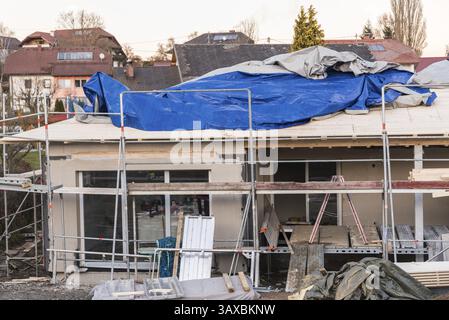 Building a bungalow - single-family house in shell construction with scaffolding, construction industry Stock Photo