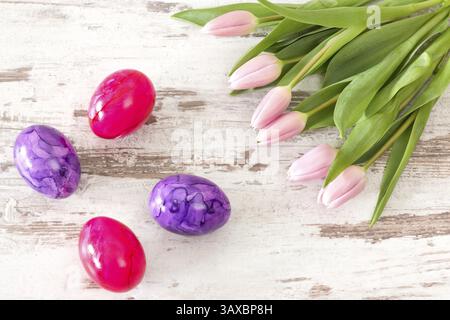 Pink tulips with Easter eggs on bright rustic wooden background Pink tulips with Easter eggs on bright rustic wooden background Stock Photo