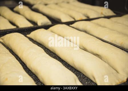 Ready-filled puff pastry on a baking tray for baking - strudel dough Stock Photo