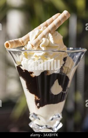Delicious sundae with vanilla ice cream, hollow cakes and chocolate sauce - Cup Denmark Stock Photo