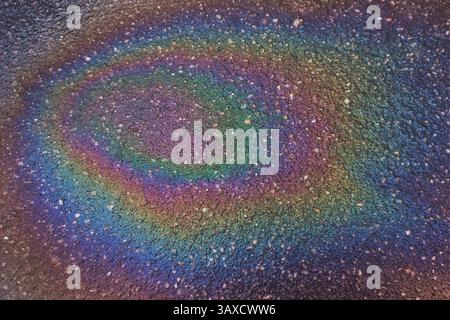 multicolor gasoline benzine stain on asphalt road surface Stock Photo