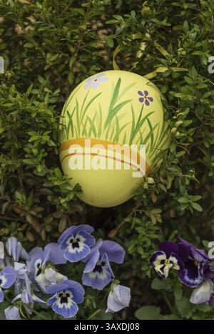 Yellow coloured and hand-painted Easter egg for an Easter decoration Stock Photo