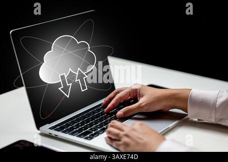 Businessperson using a laptop with cloud computing icon on the screen. Technology innovation on a virtual screen. Concept of Cloud computing technolog Stock Photo