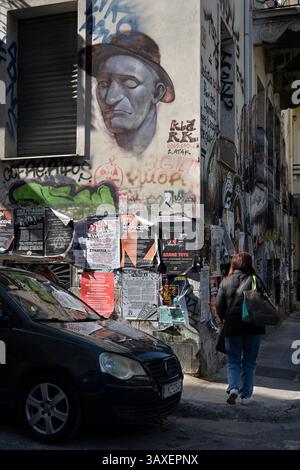 A mixture of street art, anti-facist posters  and graffiti cover a wall in the popular student district of  Exarcheia in Athens, Greece. Stock Photo
