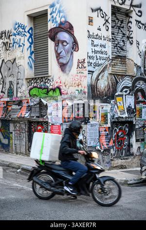 A mixture of street art, anti-facist posters  and graffiti cover a wall in the popular student district of  Exarcheia in Athens, Greece. Stock Photo