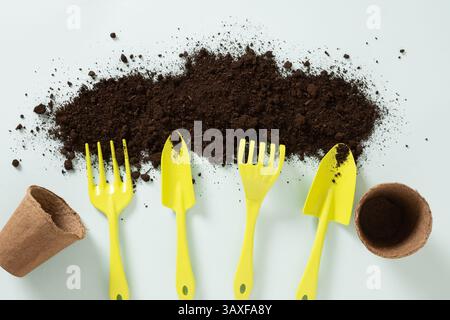 Various gardening hand green tools and soil on blue background. Concept spring gardening. Season work and hobby. View from above Stock Photo