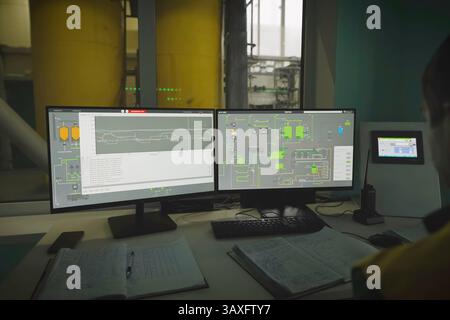 The operator at the monitors observes the technological process Stock Photo