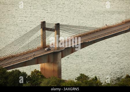 Motorcycle and vehicle traffic, crosses the Laos-Nippon Bridge over the
