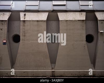Brutalist concrete Structure With Circular Openings and Geometric Details Under Diffused Light, Ljubliana Slovenia Stock Photo