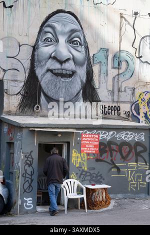 A mixture of street art  and graffiti cover a wall in the popular student district of  Exarcheia in Athens, Greece. Stock Photo
