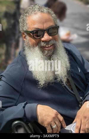 A middle aged man with a smile and long gray beard. In Washington Square Park in New York City. Stock Photo