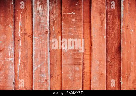 Red weathered wooden planks creating a rustic background Stock Photo
