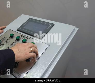 Control panel for asynchronous motors. Operator at work at the control panel. Stock Photo
