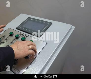 Control panel for asynchronous motors. Operator at work at the control panel. Stock Photo