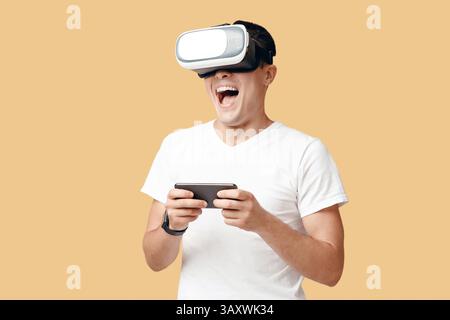 Virtual gadgets for entertainment, man using VR and phone Stock Photo