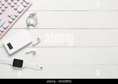 Composition with different modern gadgets on white wooden background Stock Photo