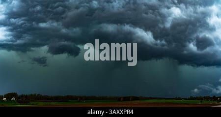Storm clouds over field, tornadic supercell, extreme weather, dangerous storm, climate change 20 Stock Photo
