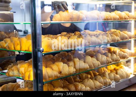 Fresh delicious croissants on display in the bakery. Food Stock Photo