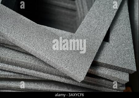 Foam frames piled together for creative gift box crafting and DIY cardboard box assembly at a vibrant workshop Stock Photo