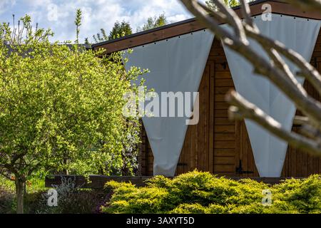 White Triangular Sunshades on Terrace Over Garden Porch Stock Photo