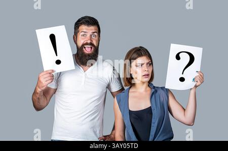 Woman and a man a question, exclamation point. Quarrel between two people. Pensive man and a thoughtful woman. Concept of question, exclamation marks Stock Photo
