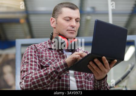 construction worker using laptop at bulding site Stock Photo