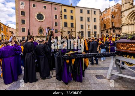 Good Friday procession En el Calvario in Cuenca. Participants in the Good Friday procession En el Calvario in Cuenca take a break in front of the cathedral. Plaza Mayor, Cuenca, Castile-La Mancha, Spain Stock Photo