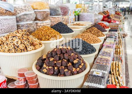 Display case with colorful nuts and dried fruits at a traditional oriental bazaar in Samarkand Stock Photo