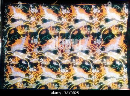 A vibrant textile featuring a whimsical pattern of leaping deer among intricate floral motifs, showcasing a rich array of colors and detailed embroidery. The design combines nature and fantasy, creating a visually captivating piece., Islamic, Iranian, Textile, 1600s, Silk threads, 13 1/4 x 18 1/2 in., Classic art with a modern twist reimagined by Artotop Stock Photo