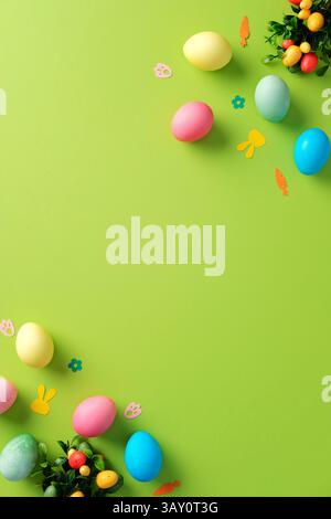 Easter vertical background. Top view colorful Easter eggs and festive decorations on green table. Stock Photo