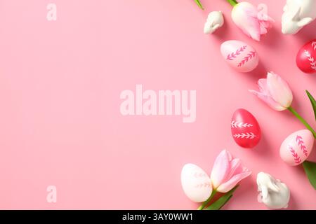 Happy Easter card template. Easter eggs, tulips, decorative bunnies on pink background. Stock Photo