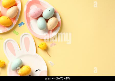 Happy Easter flat lay composition with colorful Easter eggs on cute plates. Stock Photo