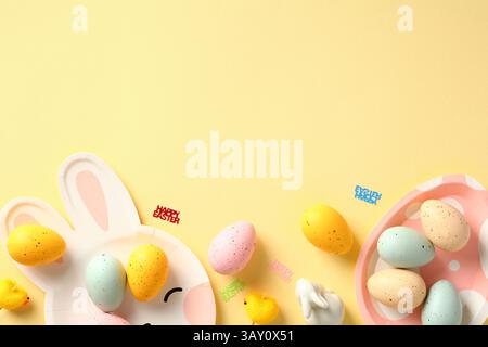 Happy Easter banner template. Frame border made of cute plate with colorful Easter eggs, decorative chickens, rabbits on pastel yellow background. Stock Photo