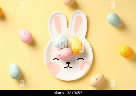 Happy Easter concept. Cute plate in shape of bunny with colorful Easter eggs Stock Photo