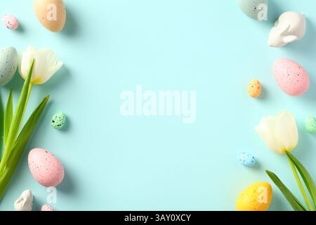 Happy Easter greeting card template. Double border frame made of colorful Easter eggs, tulips, decorative bunny. Stock Photo