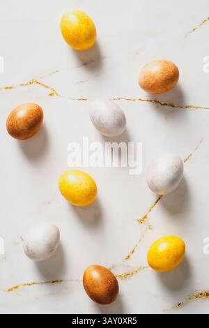 Luxury Easter eggs on marble table. Flat lay, top view, vertical Stock Photo