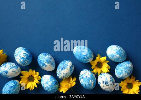 Blue and white Easter eggs with yellow flowers. Happy Easter card Stock Photo