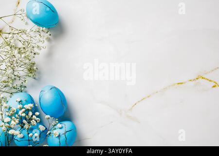 White background with blue eggs and white flowers. Happy Easter concept. Stock Photo