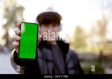 teenager showing cell phone screen to camera Stock Photo