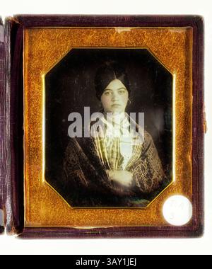 A young woman stands confidently, dressed in traditional attire. She wears a patterned shawl draped over her shoulders and a headscarf. Her expression is serious yet poised, capturing a moment of dignity and cultural identity., Unknown (American), Portrait of a Woman, 19th century, daguerreotype with hand coloring, Overall (case, closed): 3 5/8 × 3 1/4 × 5/8 inches (9.2 × 8.3 × 1.6 cm), Classic art with a modern twist reimagined by Artotop Stock Photo