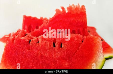 Close-up of ripe juicy red watermelon pieces on white background Stock Photo